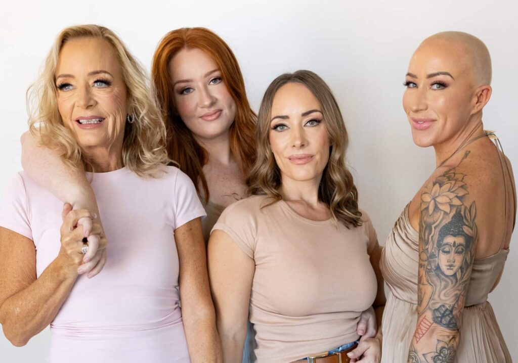Kayla Marie, Katrina, and Donna, co-founders of Third Eye Beauty Lounge, standing together inside the studio, smiling with confidence and warmth.