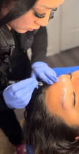 Brow artist performing brow lamination service at Third Eye Beauty Lounge in Tempe, AZ