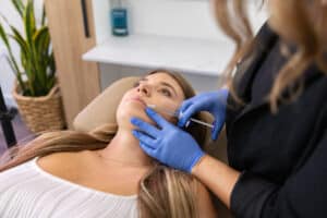 Cosmetic Nurse Injector Katrina performing a precise lip filler injection at Third Eye Beauty Lounge, a top medical spa in Tempe, Arizona.