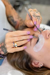 Close-up of professional lash artist applying eyelash extensions at Third Eye Beauty Lounge in Tempe, AZ, showing detailed precision, soft volume lashes, and premium tools for perfect retention.