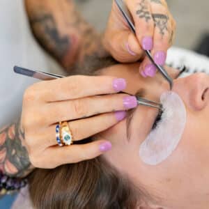 Close-up of professional lash artist applying eyelash extensions at Third Eye Beauty Lounge in Tempe, AZ, showing detailed precision, soft volume lashes, and premium tools for perfect retention.