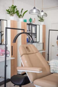 A modern treatment room inside Third Eye Beauty Lounge in Tempe, Arizona, featuring soft lighting, aesthetic décor, and a luxury treatment chair used for cosmetic injectables, skincare, and lash services.
